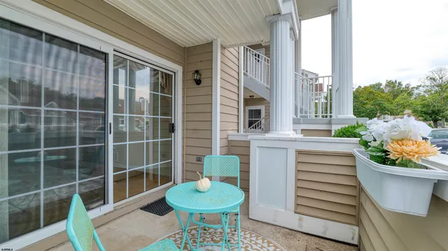 a view of a chair and table in the back yard of the house