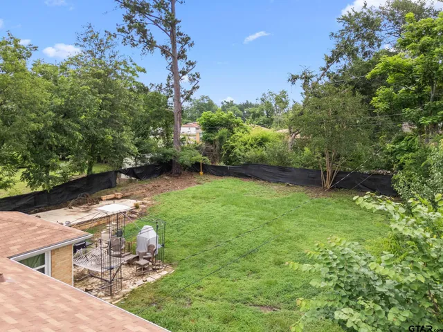 a backyard of a house with lots of green space