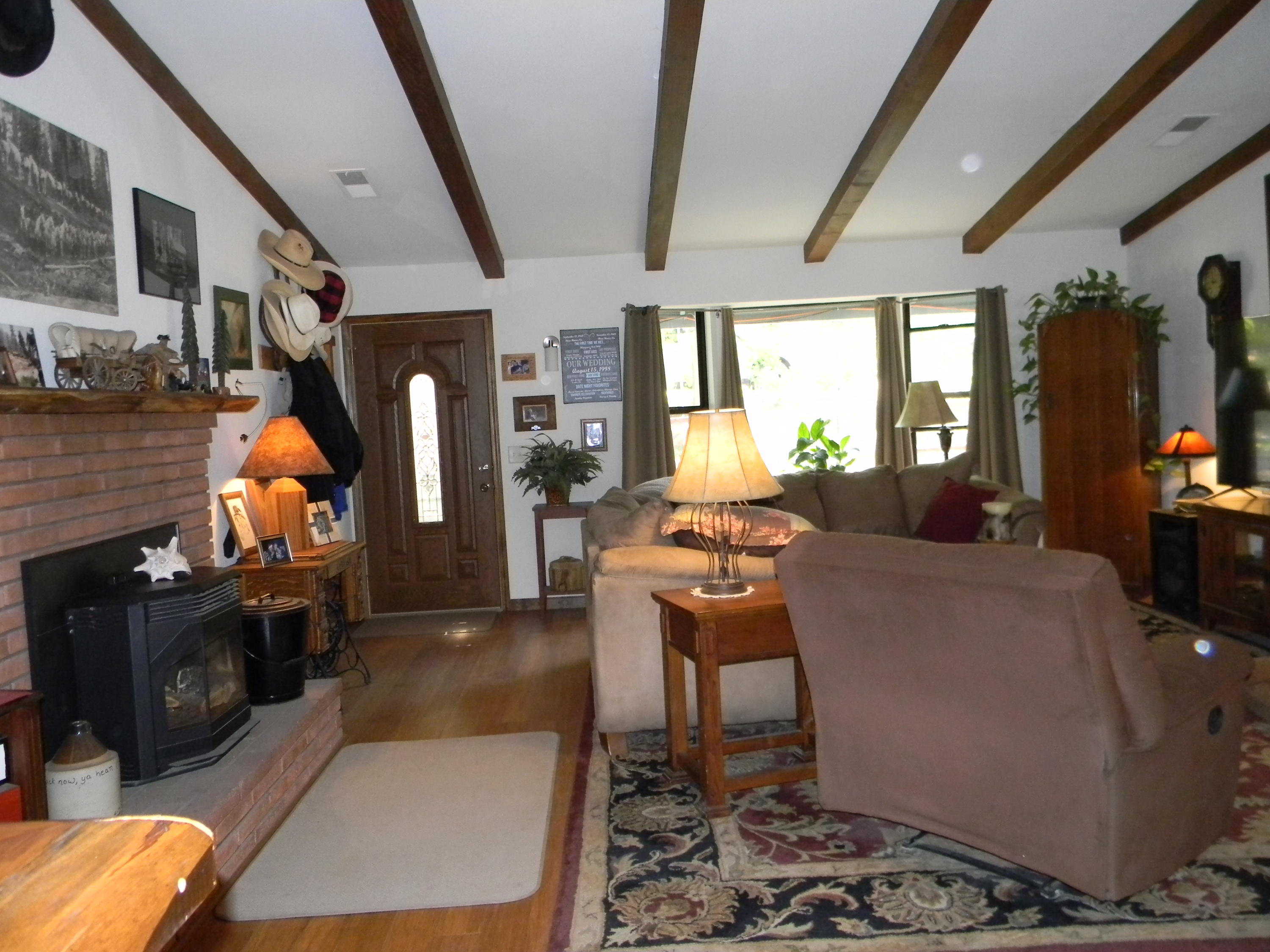 40992 Meadow Drive Three Rivers, CA 93271 - Photo 17 of 29 a living room with furniture a rug and a fireplace