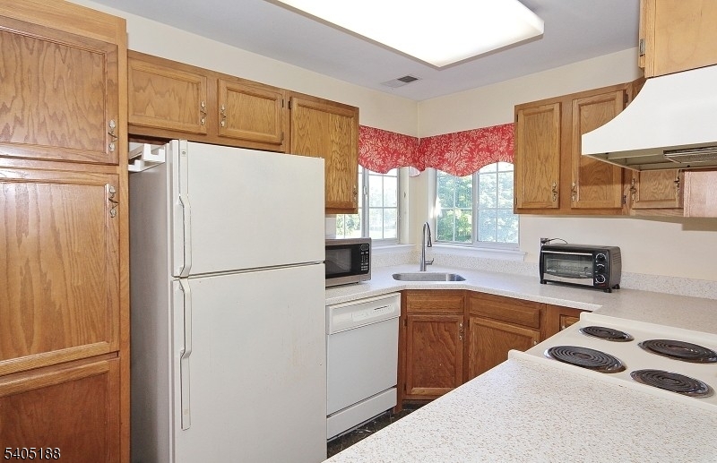 58 Wescott Road Bedminster, NJ 07921 - Photo 5 of 13 a white refrigerator freezer sitting inside of a kitchen