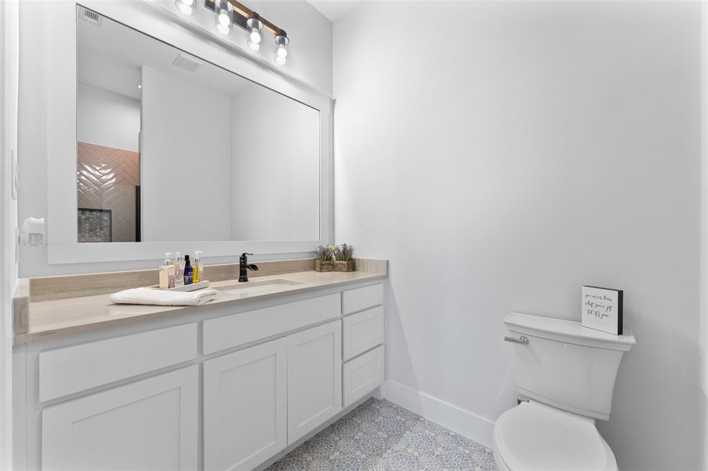 4411 Fm 751 Wills Point Wills Point, TX 75169 - Photo 29 of 40 Bathroom featuring a white shaker-style vanity with ample storage, light-toned countertop, rectangular undermount sink, and matte black faucet