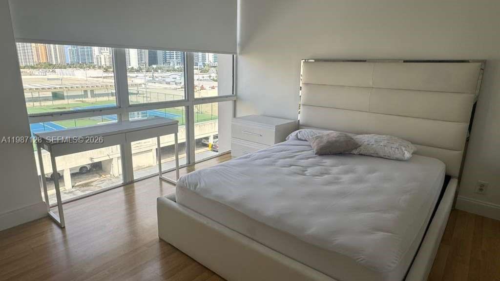 16909 North Bay Road, Unit 710 Sunny Isles Beach, FL 33160 - Photo 13 of 19 a bedroom with a large bed and a large window