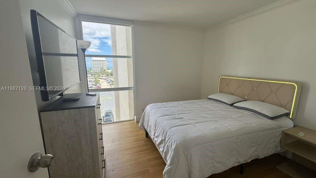 16909 North Bay Road, Unit 710 Sunny Isles Beach, FL 33160 - Photo 15 of 19 a bedroom with a bed and a window