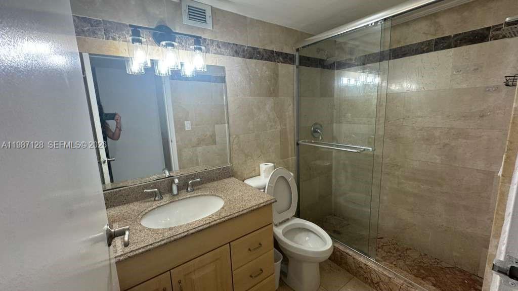 16909 North Bay Road, Unit 710 Sunny Isles Beach, FL 33160 - Photo 16 of 19 a bathroom with a sink toilet and shower