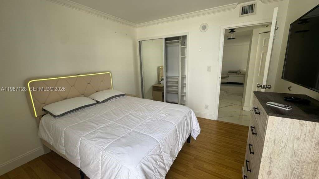 16909 North Bay Road, Unit 710 Sunny Isles Beach, FL 33160 - Photo 17 of 19 a bedroom with a bed and a flat screen tv