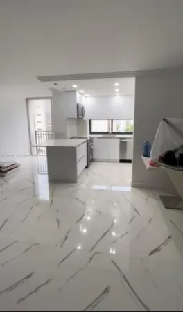 a view of a kitchen with a sink and cabinets