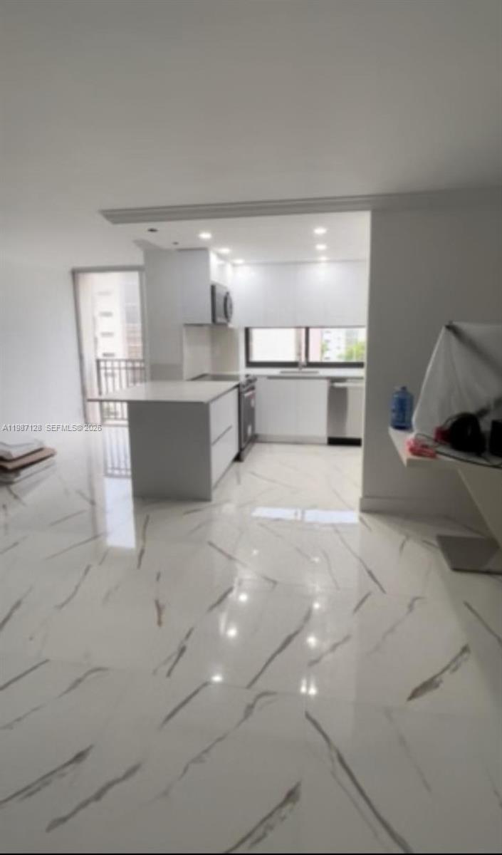 16909 North Bay Road, Unit 710 Sunny Isles Beach, FL 33160 - Photo 3 of 19 a view of a kitchen with a sink and cabinets