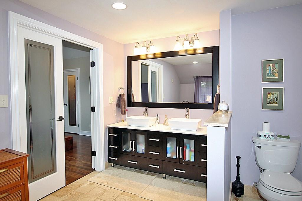 764 Osage Road Mt. Lebanon, PA 15243 - Photo 12 of 24 Master bathroom with a stone floor, built in vanity with porcelain sinks. Recessed lighting.