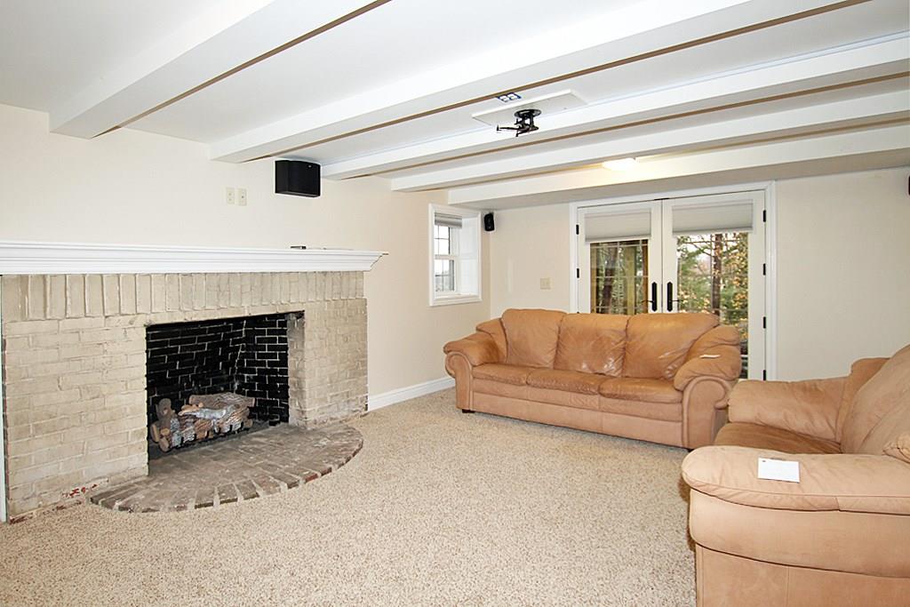 764 Osage Road Mt. Lebanon, PA 15243 - Photo 20 of 24 Game room with a log burning fireplace and French doors to the back yard.