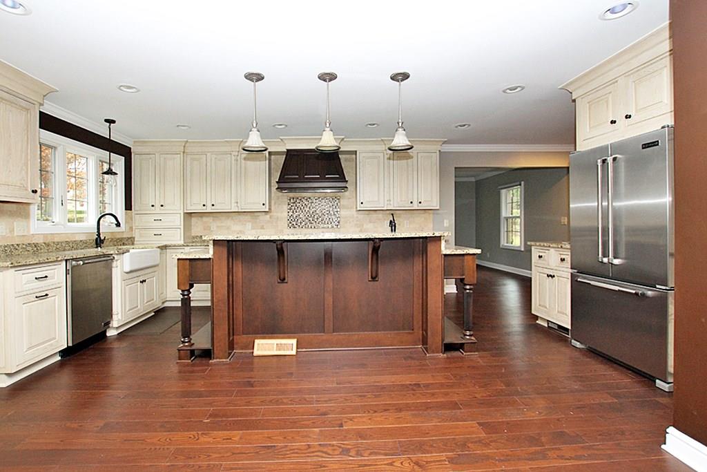 764 Osage Road Mt. Lebanon, PA 15243 - Photo 4 of 24 Amazing gourmet kitchen with a breakfast bar, inset cabinetry, granite counter tops and subway stone tile back splash. Stainless appliances and gas stone. Separate dining area with a wine cooler.