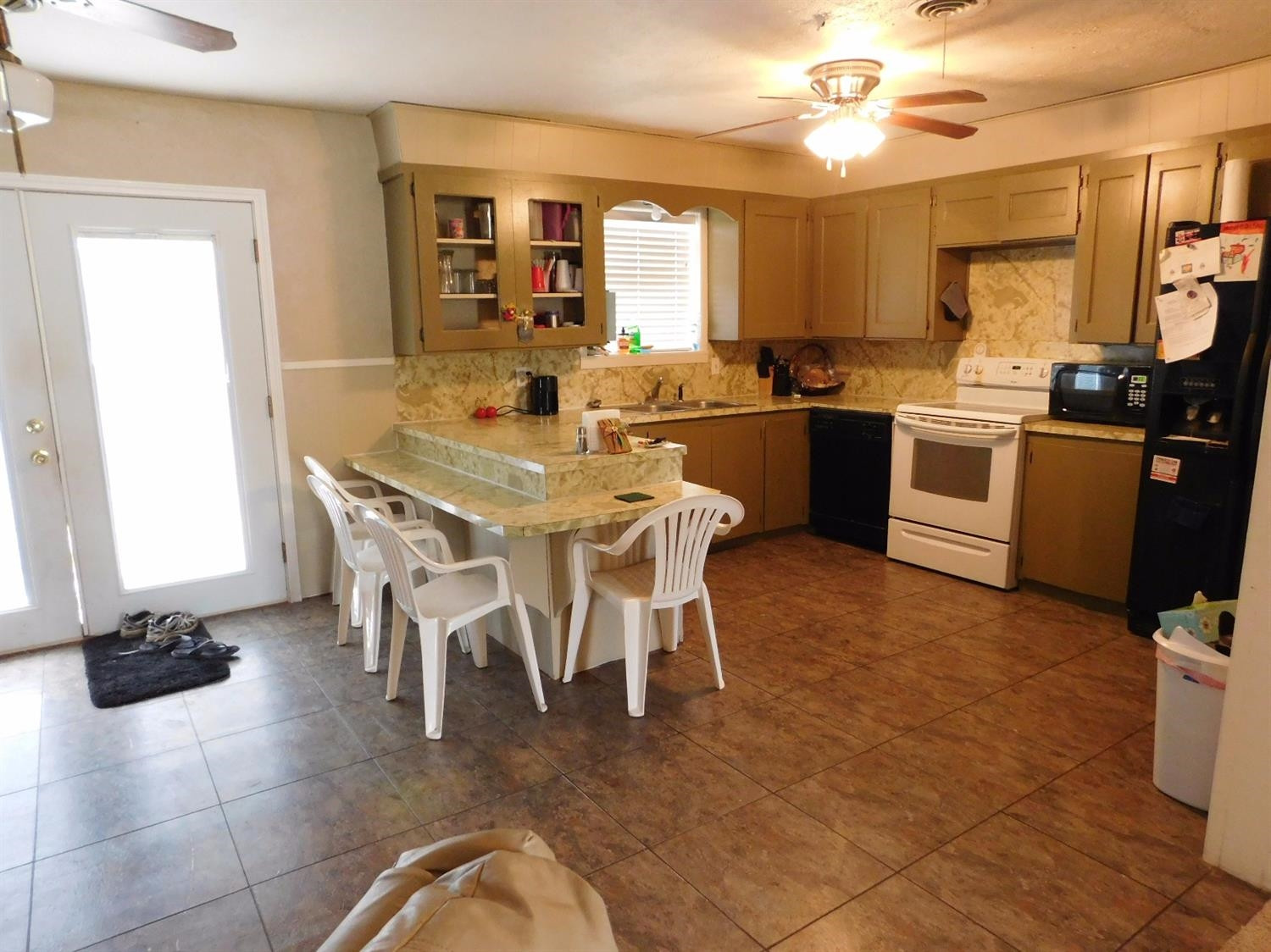 904 West 7th Street Muleshoe, TX 79347 - Photo 3 of 10 a kitchen with stainless steel appliances granite countertop a stove top oven a sink a dining table and chairs
