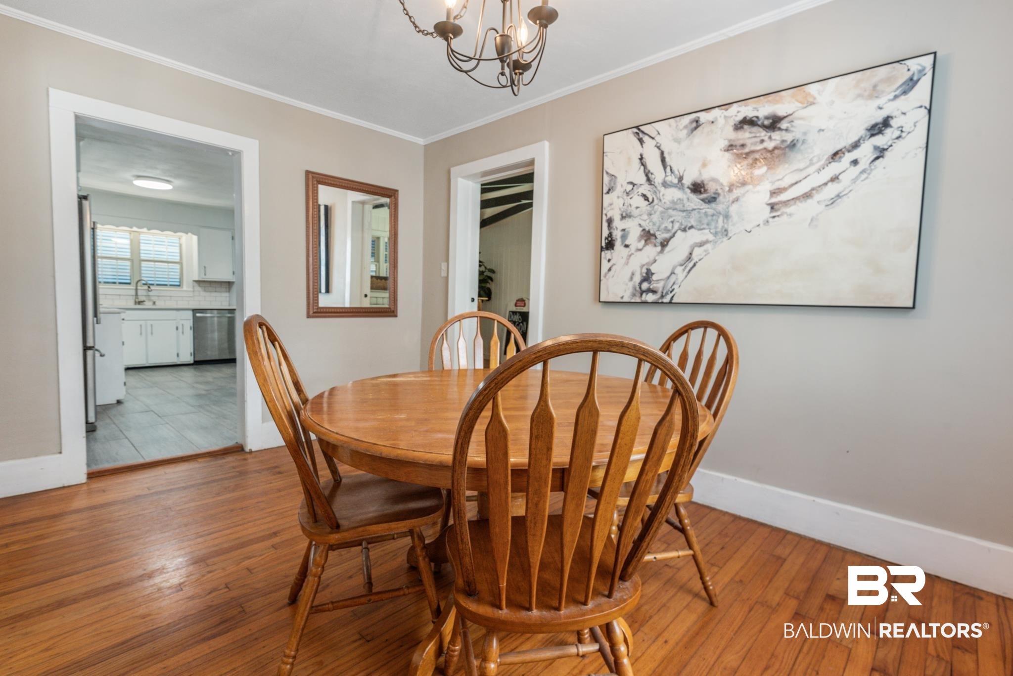 114 Crenshaw Street Mobile, AL 36606 - Photo 16 of 49 Tiled dining room with sink, crown molding, and a chandelier