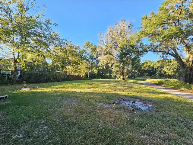 a view of outdoor space with swimming pool and green space