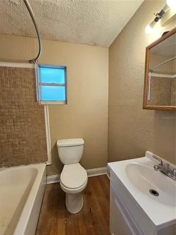 a bathroom with a sink a toilet and bathtub