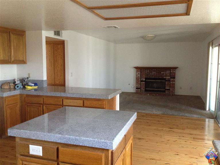 5115 Claro Way Palmdale, CA 93551 - Photo 4 of 7 a kitchen with stainless steel appliances granite countertop a stove a sink and a microwave