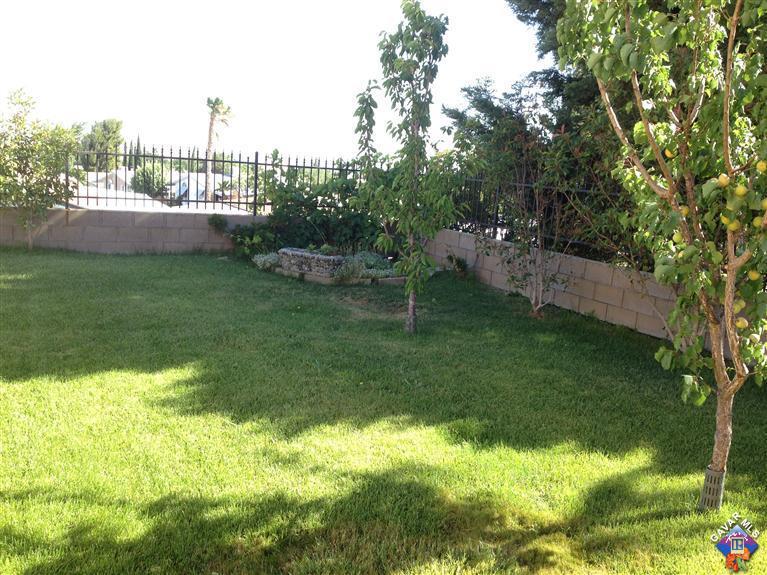 5115 Claro Way Palmdale, CA 93551 - Photo 6 of 7 a view of a garden with a building in the background