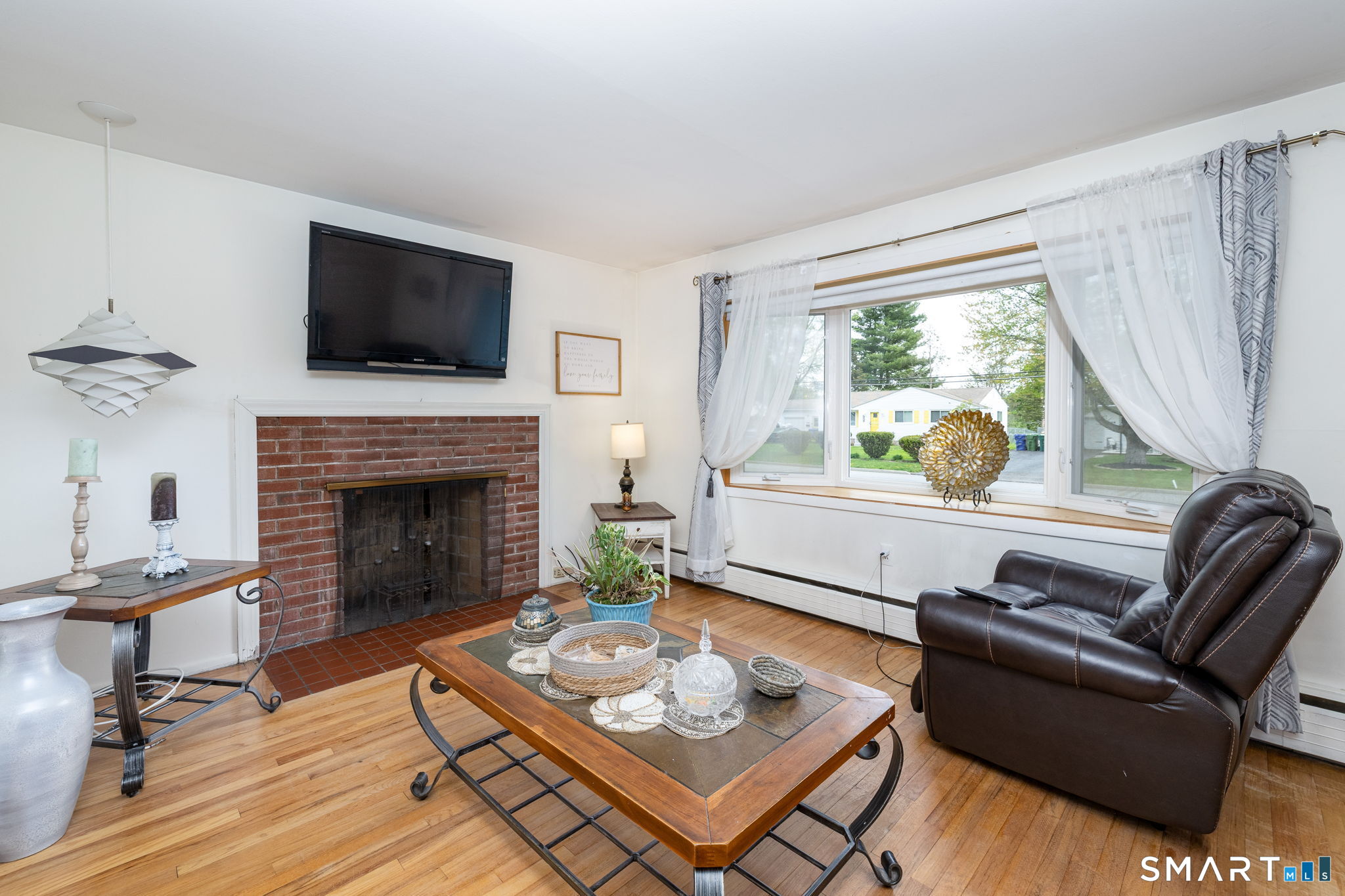 325 Barbara Road Middletown, CT 06457 - Photo 17 of 40 a living room with furniture a flat screen tv and a fireplace