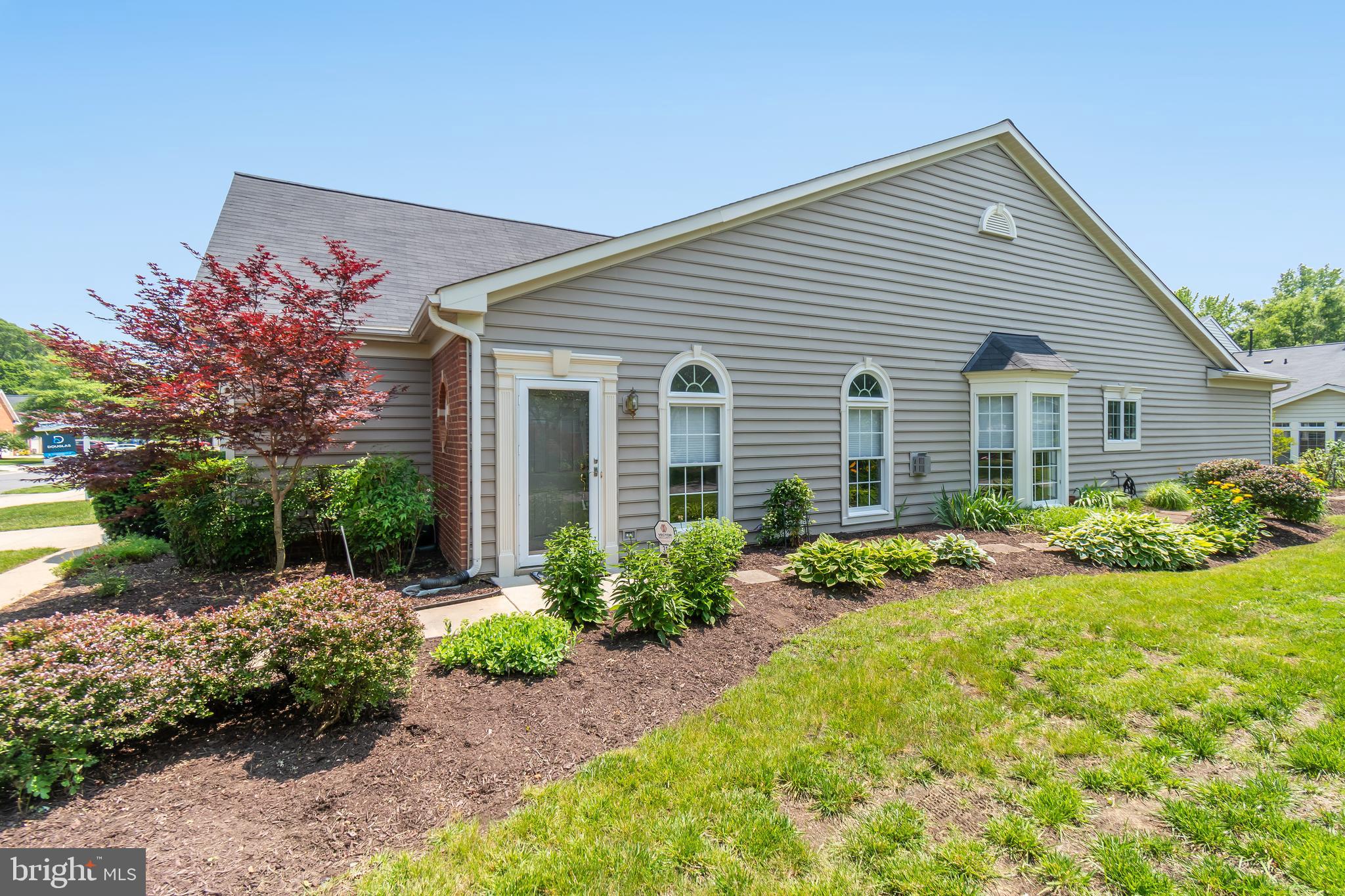 a front view of a house with garden and porch