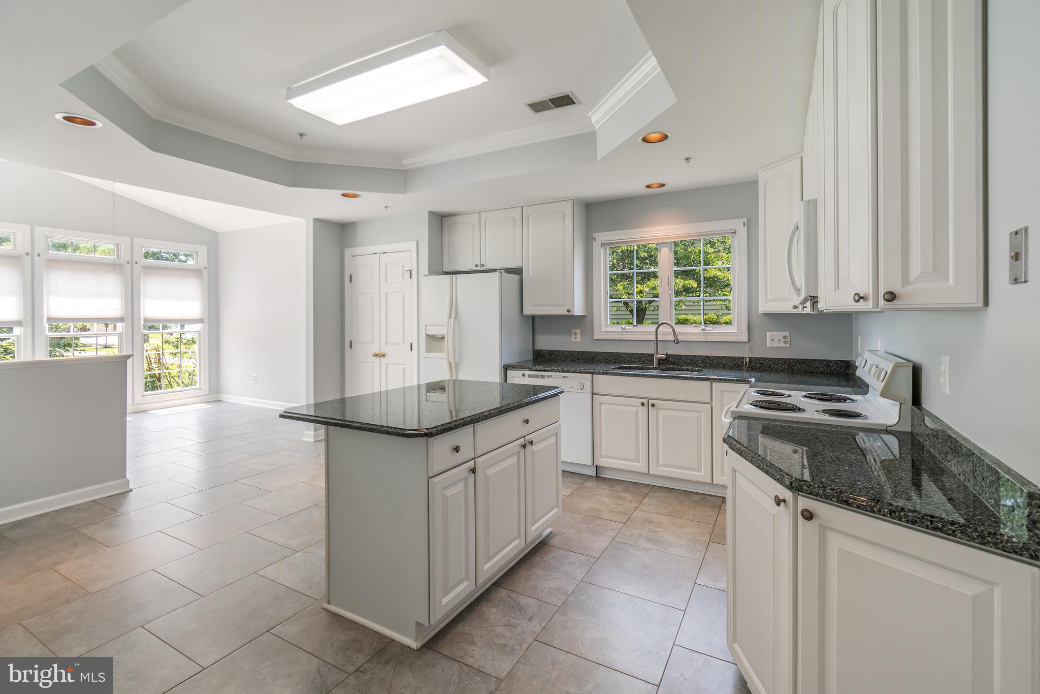 314 Colony Point Place Edgewater, MD 21037 - Photo 17 of 31 a kitchen with granite countertop white cabinets white appliances a sink and a window