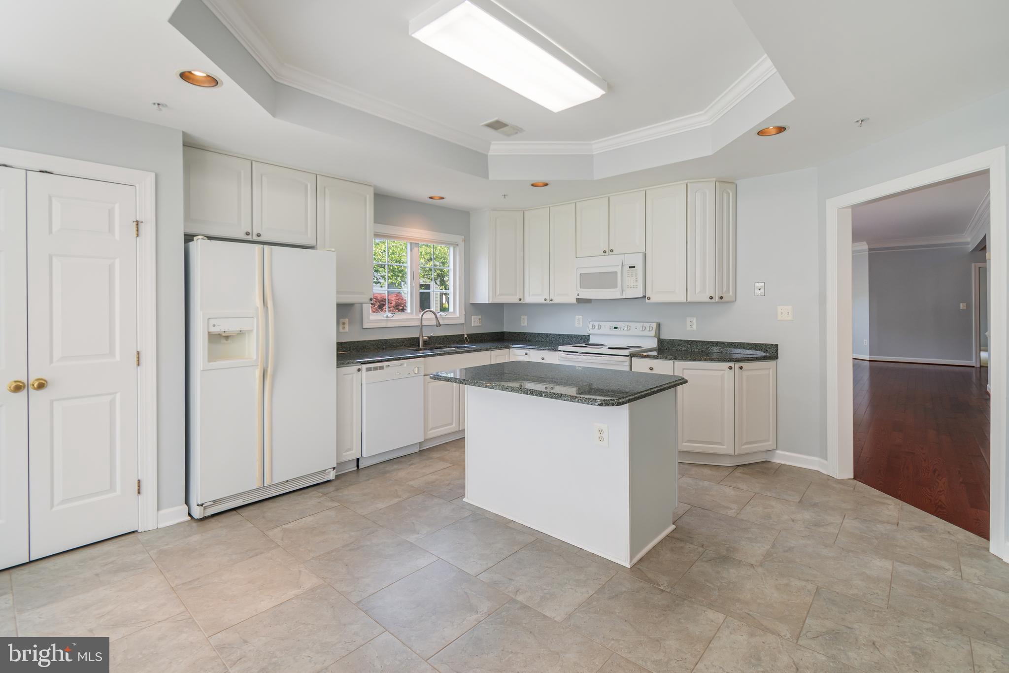 314 Colony Point Place Edgewater, MD 21037 - Photo 18 of 31 a kitchen with white cabinets and refrigerator