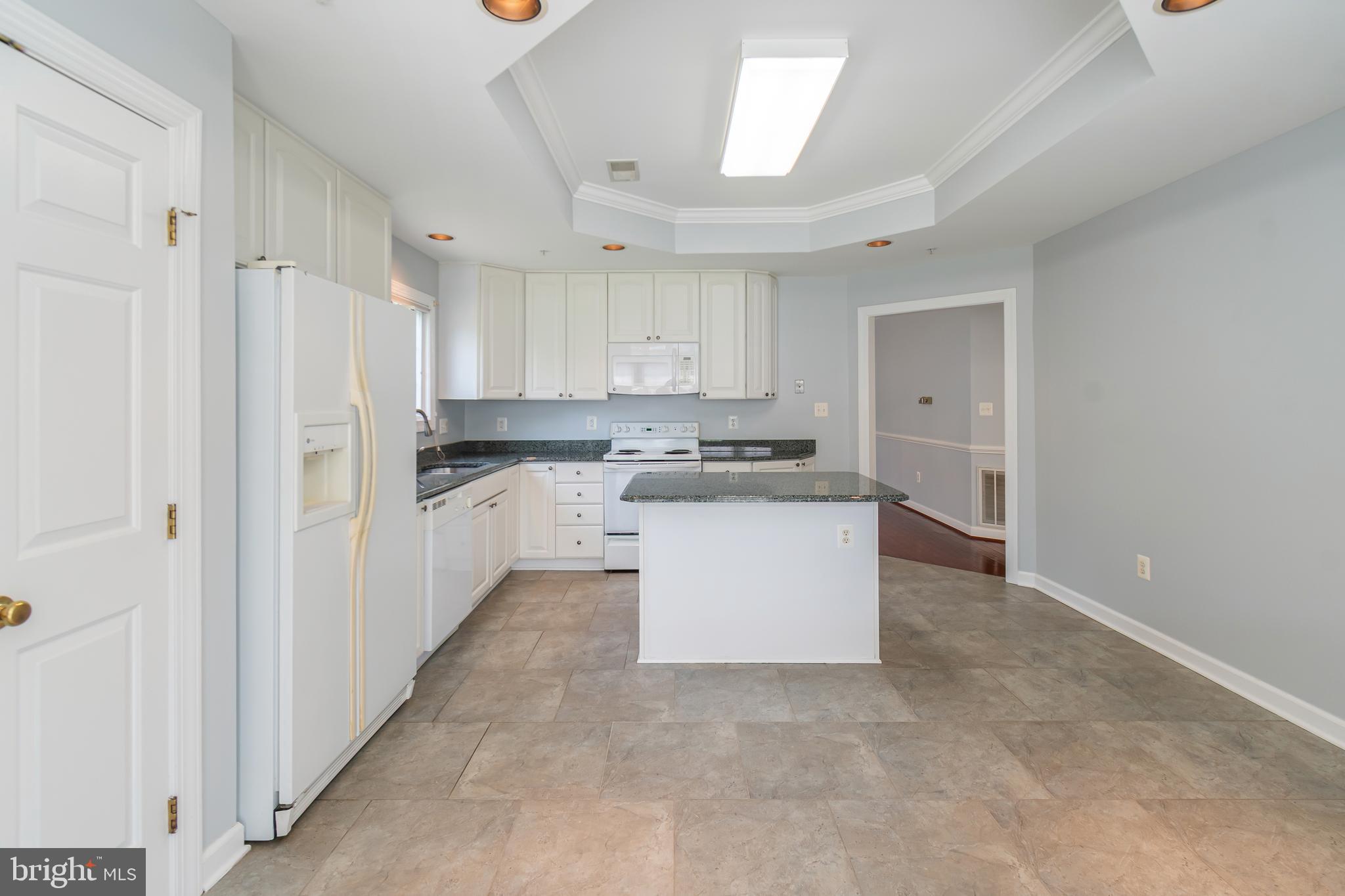 314 Colony Point Place Edgewater, MD 21037 - Photo 19 of 31 a kitchen with white cabinets and white appliances