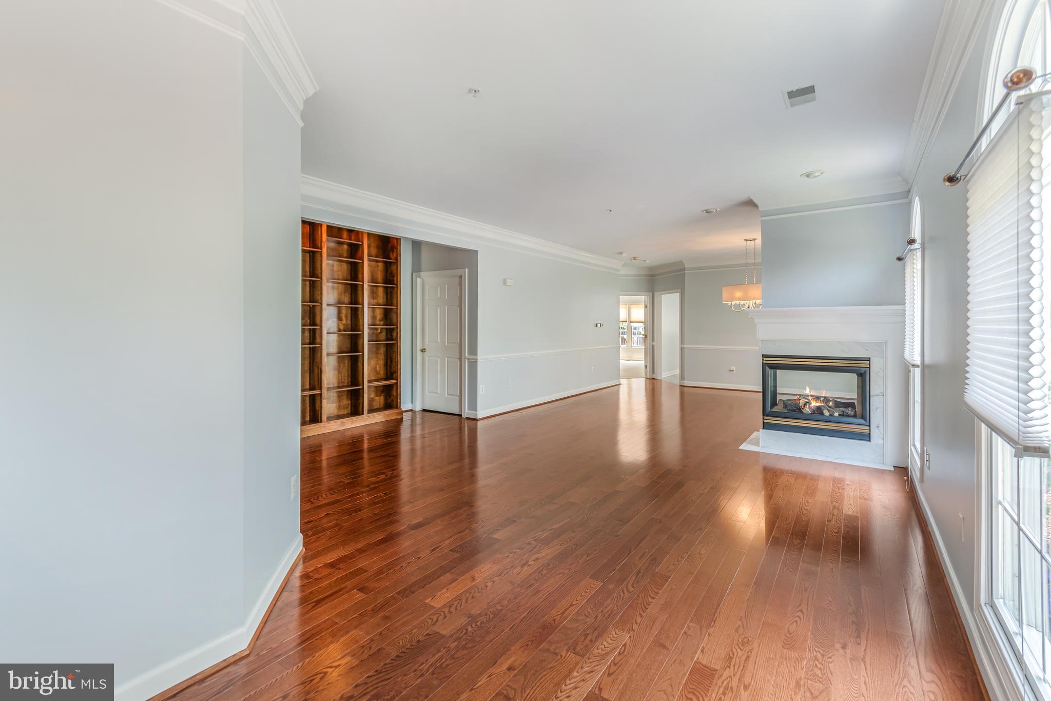 314 Colony Point Place Edgewater, MD 21037 - Photo 5 of 31 an empty room with wooden floor and fireplace