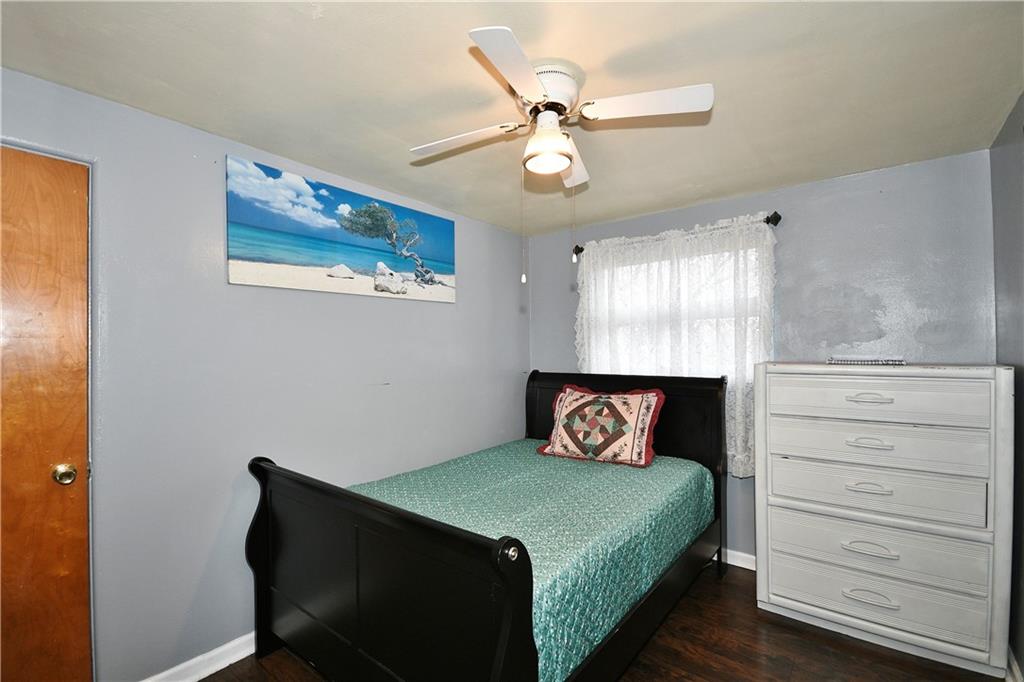 1619 Hollyrood Road Pittsburgh, PA 15227 - Photo 15 of 25 a bedroom with a bed and a chandelier