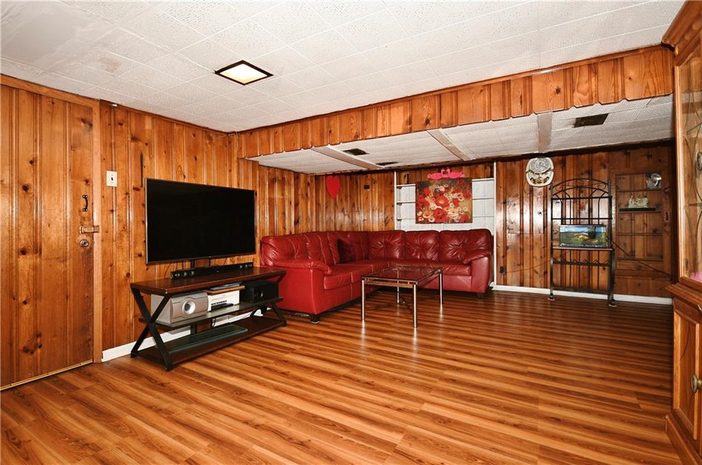 1619 Hollyrood Road Pittsburgh, PA 15227 - Photo 19 of 25 a living room with furniture a flat screen tv and wooden floor