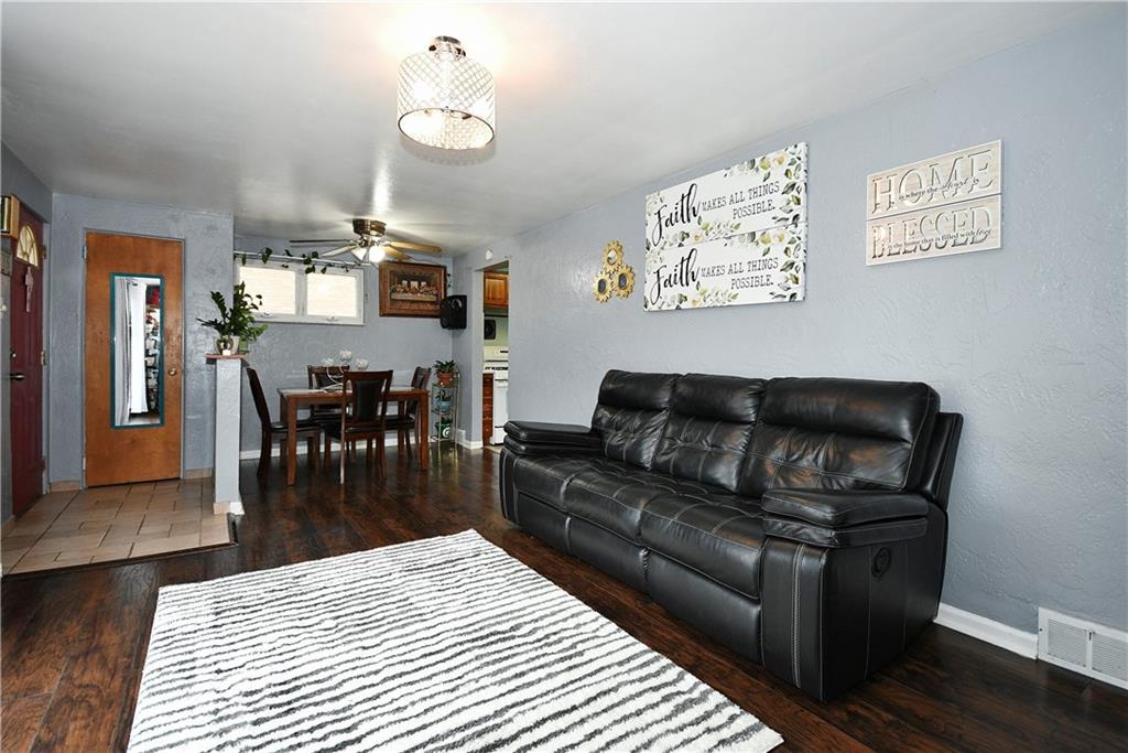 1619 Hollyrood Road Pittsburgh, PA 15227 - Photo 7 of 25 a living room with furniture a dining table and wooden floor