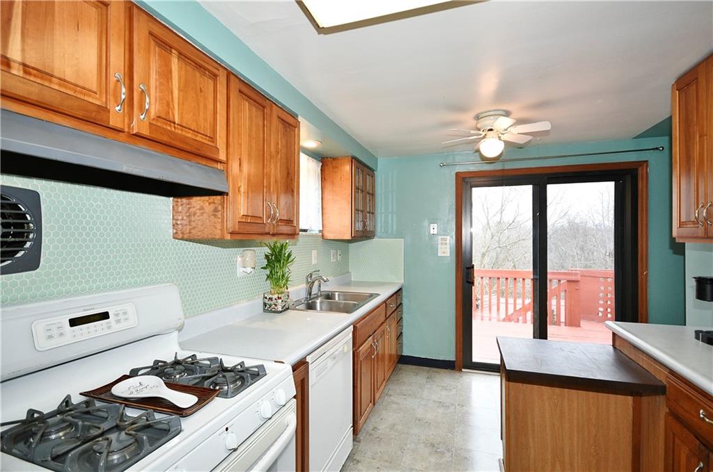 1619 Hollyrood Road Pittsburgh, PA 15227 - Photo 8 of 25 a kitchen with a stove a sink and a cabinets