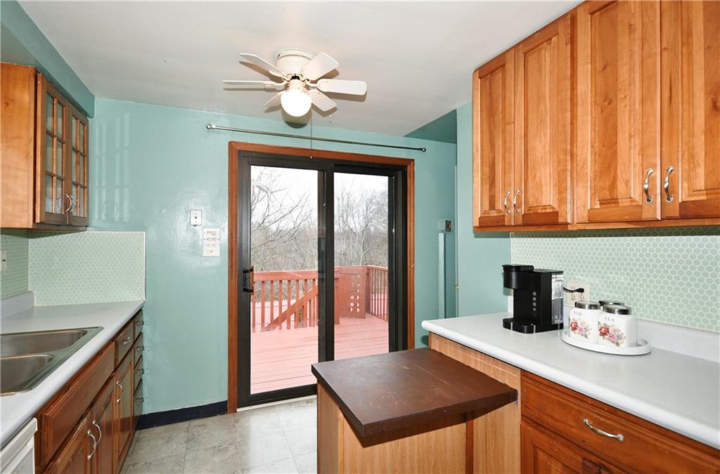 1619 Hollyrood Road Pittsburgh, PA 15227 - Photo 10 of 25 a kitchen with stainless steel appliances granite countertop a sink a stove and a wooden cabinets