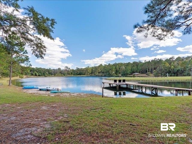 4650 Wiggins Lane Wilmer, AL 36587 - Photo 50 of 66 Dock with a forest view, a yard, and a water view