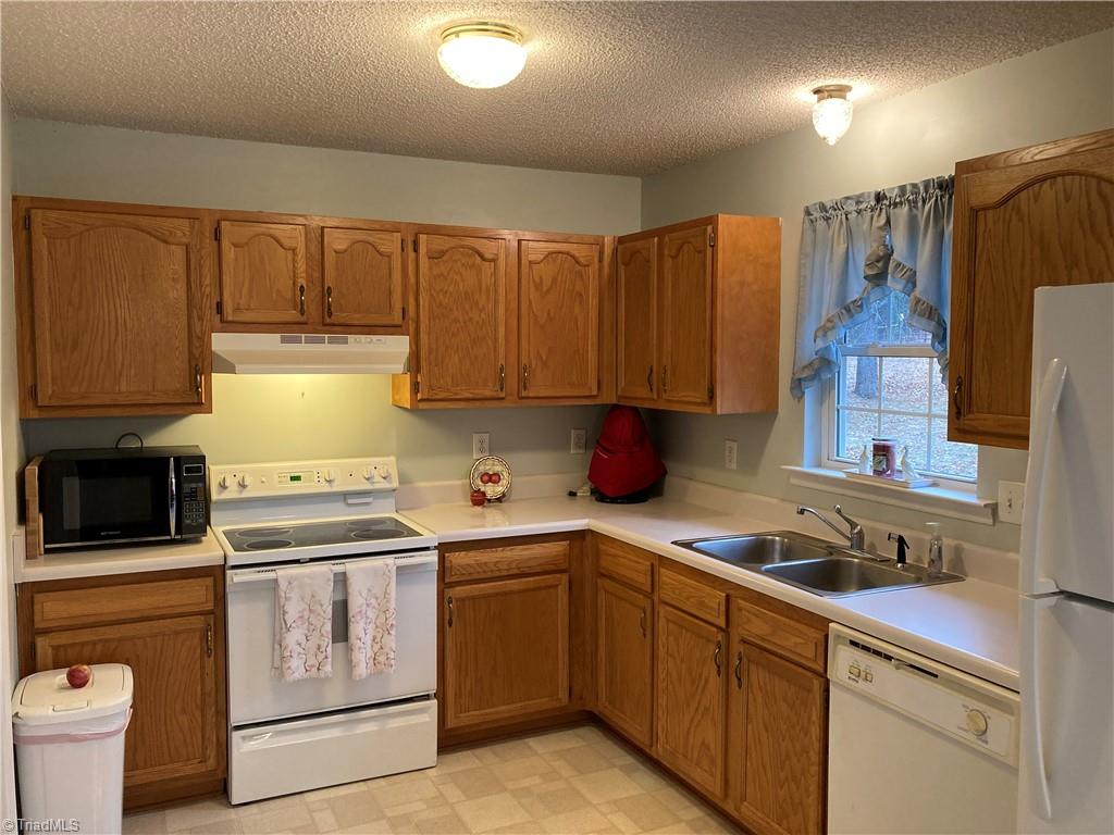 2811 Regal Road Reidsville, NC 27320 - Photo 15 of 19 Kitchen with flat top stove. Lots of natural light throughout the day