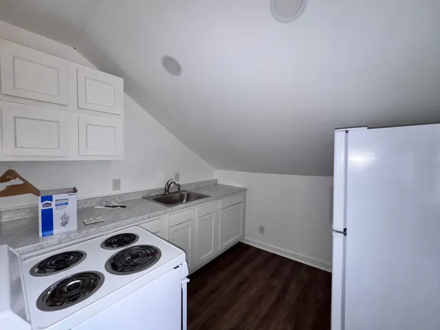 a kitchen with a sink a stove and cabinets
