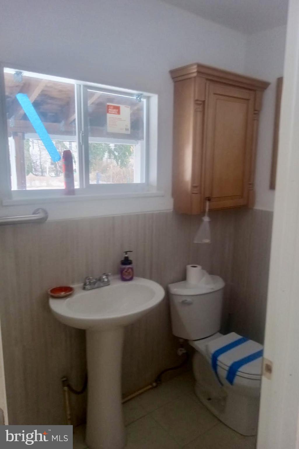 204 Bridgeton Avenue Fortescue, NJ 08321 - Photo 4 of 17 a bathroom with a sink toilet and a window