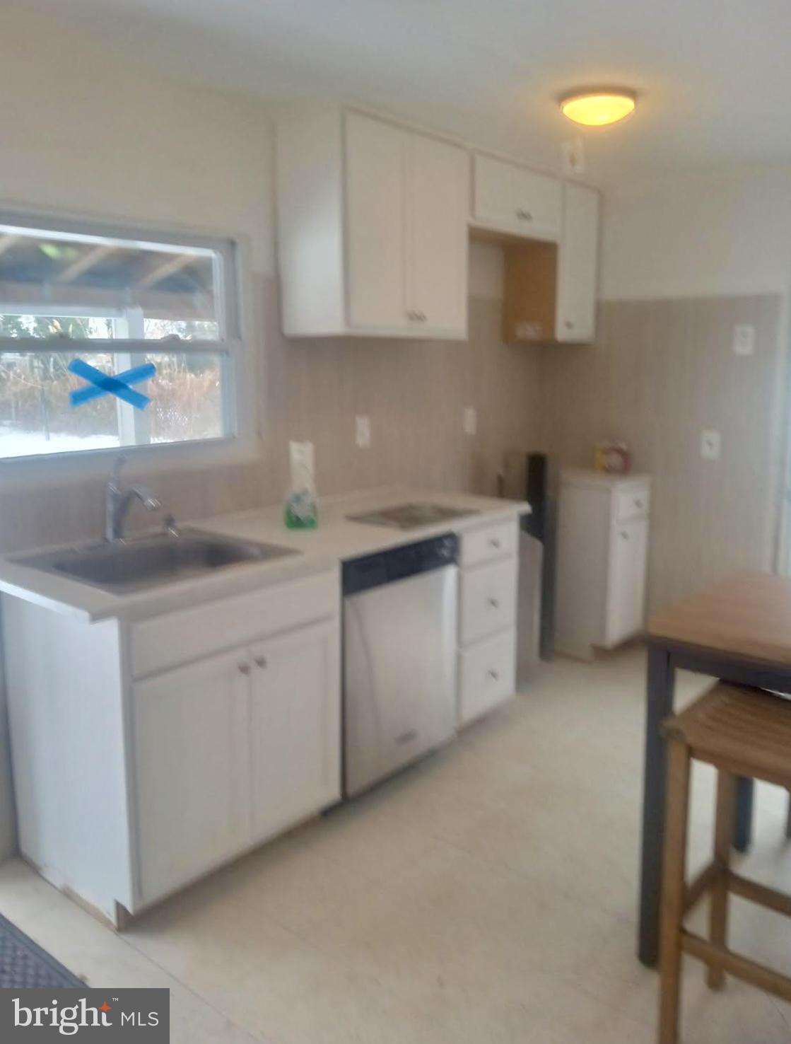 204 Bridgeton Avenue Fortescue, NJ 08321 - Photo 5 of 17 a kitchen with white cabinets and a sink