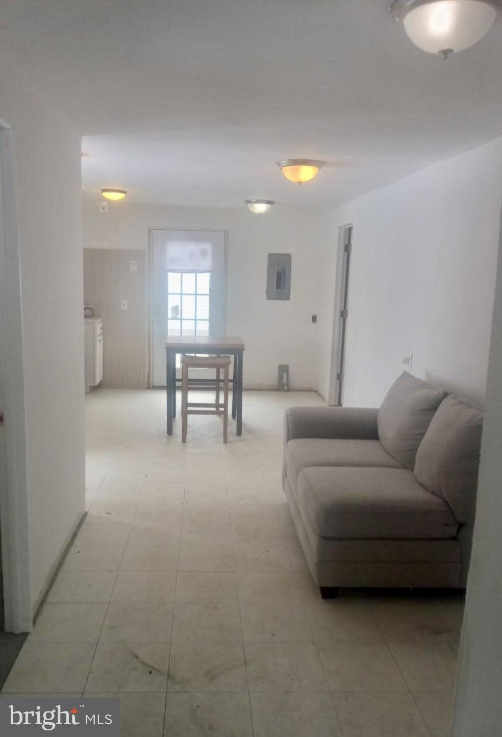 204 Bridgeton Avenue Fortescue, NJ 08321 - Photo 6 of 17 a living room with furniture and a chandelier