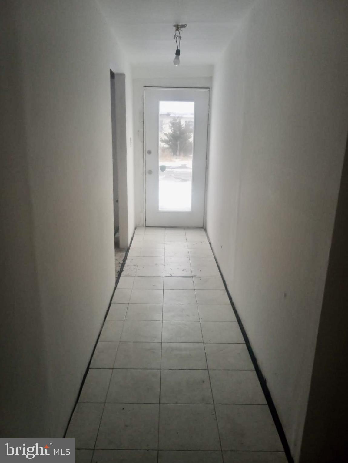 204 Bridgeton Avenue Fortescue, NJ 08321 - Photo 9 of 17 a hallway with window and front door