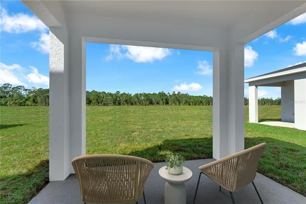 a view of a patio with lawn chairs and a table
