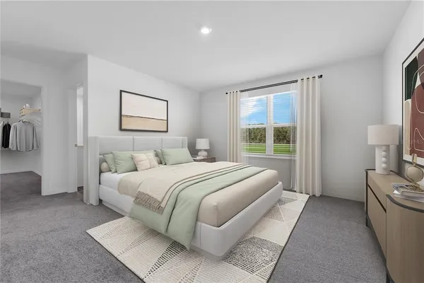 a bedroom with a large bed and a couch