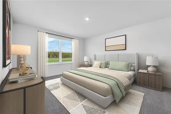 a bedroom with a bed and a lamp