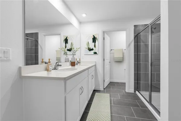 a bathroom with a double vanity sink mirror and shower