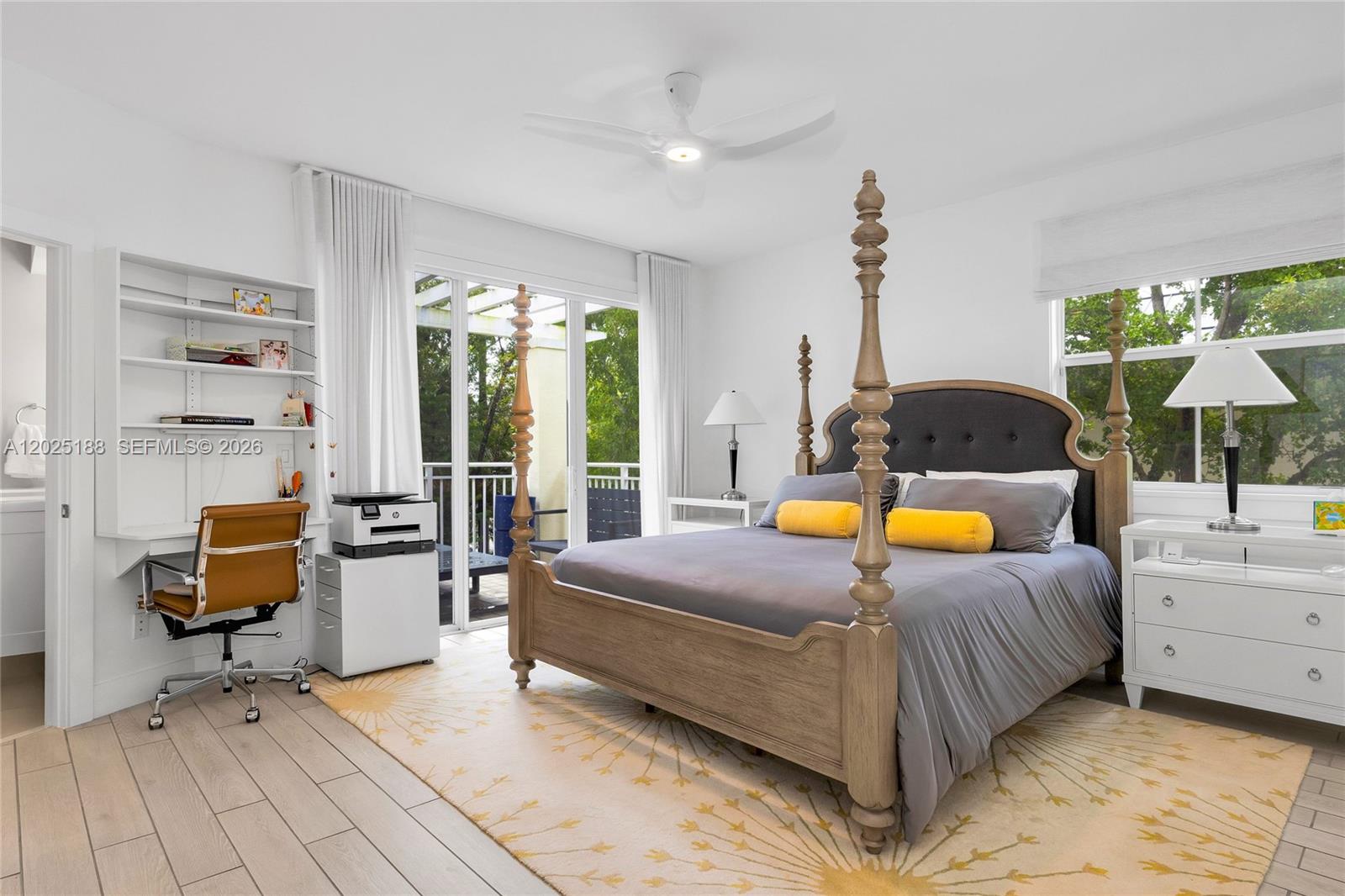 7620 Southwest 102nd Street, Unit 121 Pinecrest, FL 33156 - Photo 9 of 18 a bedroom with a bed and large windows