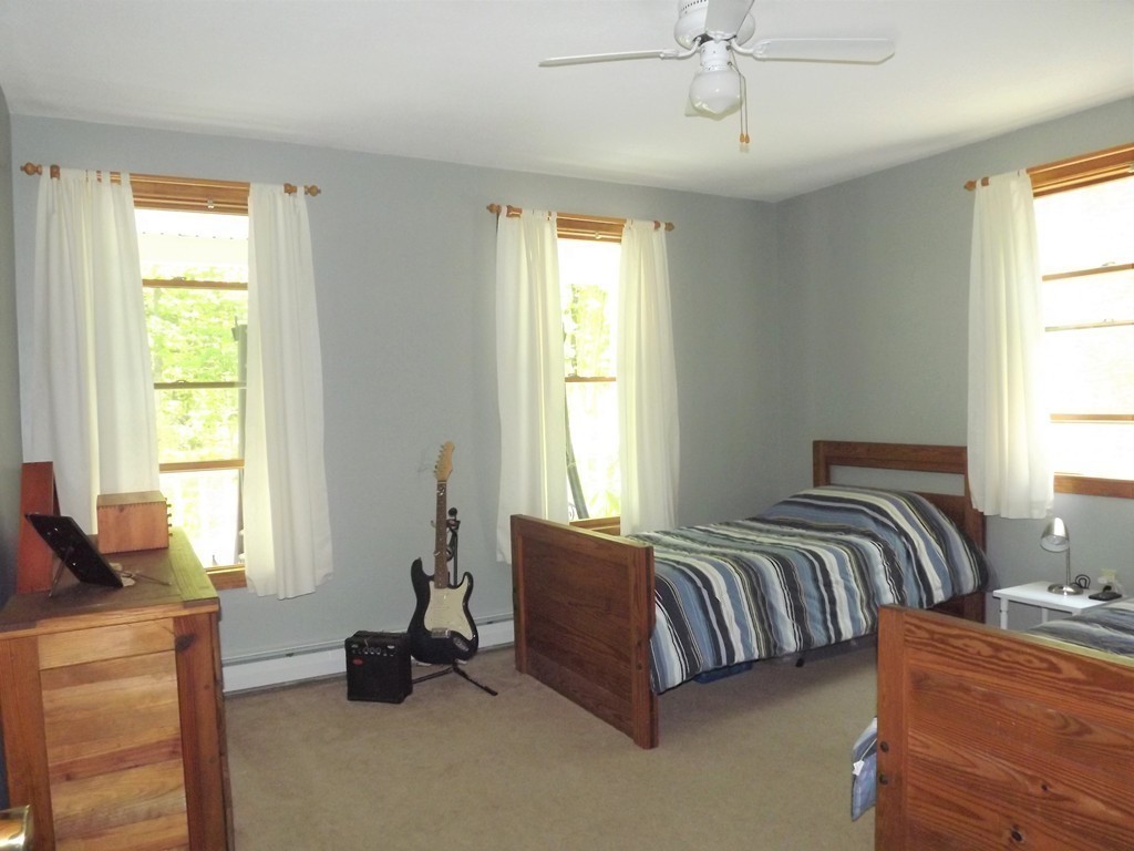 343 Cedar Swamp Road Monson, MA 01057 - Photo 8 of 24 a spacious bedroom with a bed and a window