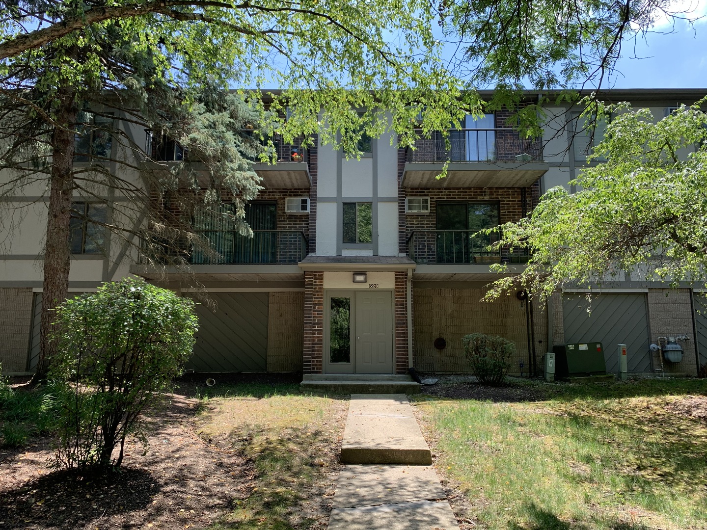 528 East Bailey Road, Unit 102 Naperville, IL 60565 - Photo 1 of 8 a front view of a house with garden