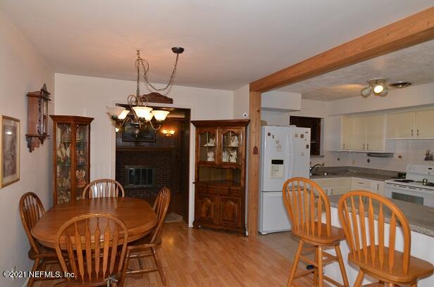 6324 Anvil Road Jacksonville, FL 32277 - Photo 14 of 34 a dining room filled chandelier and wooden floor