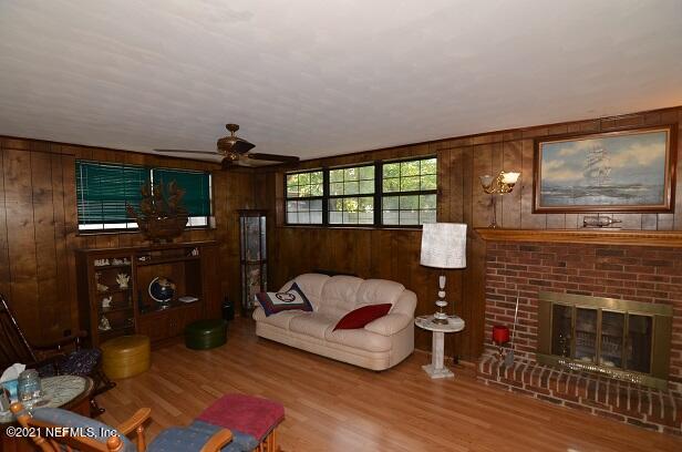 6324 Anvil Road Jacksonville, FL 32277 - Photo 15 of 34 a living room with furniture a flat screen tv and a fireplace