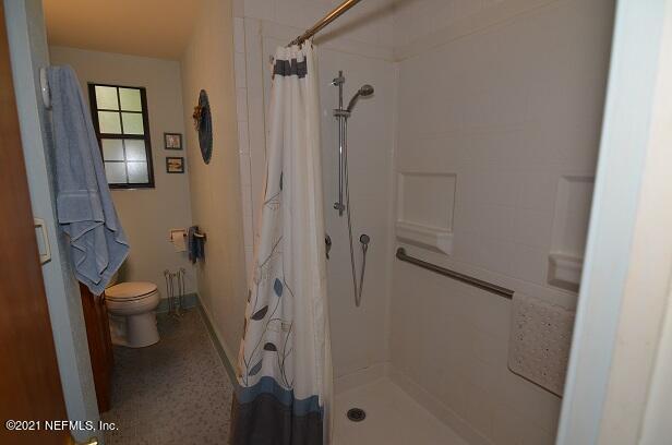 6324 Anvil Road Jacksonville, FL 32277 - Photo 20 of 34 a bathroom with a granite countertop shower and a toilet