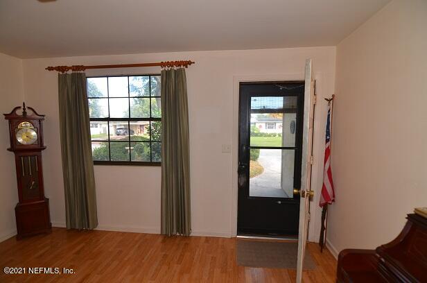 6324 Anvil Road Jacksonville, FL 32277 - Photo 3 of 34 a view of a hallway with wooden floor and windows