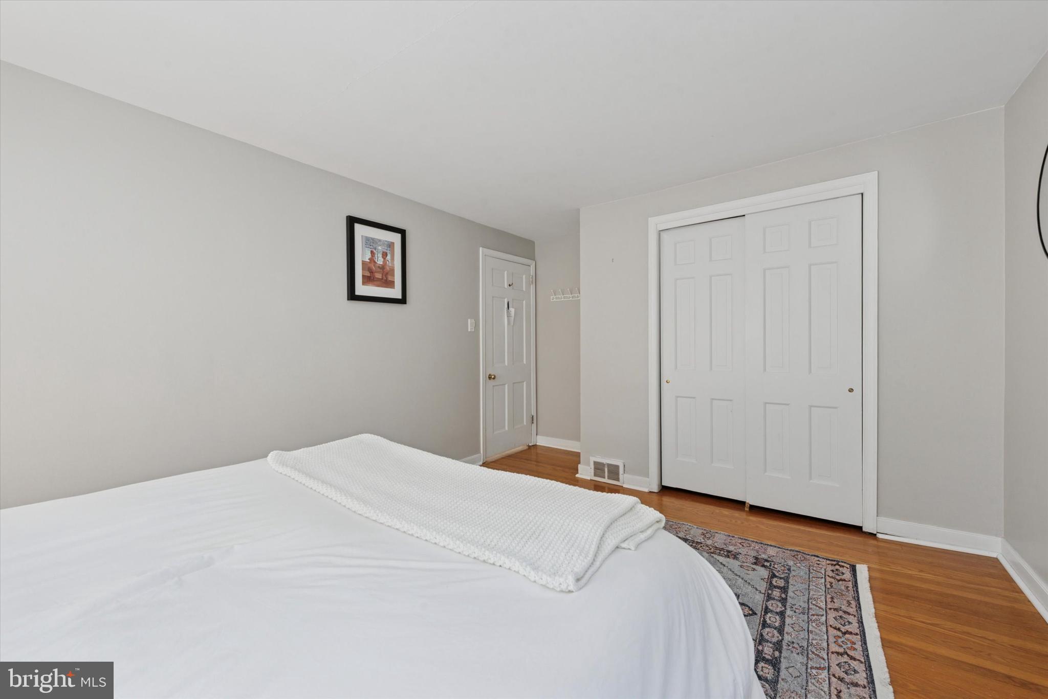 103 Deepdale Road Wayne, PA 19087 - Photo 26 of 41 a bedroom with a bed and wooden floor